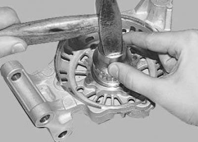 15. Press the bearing out of the cover.