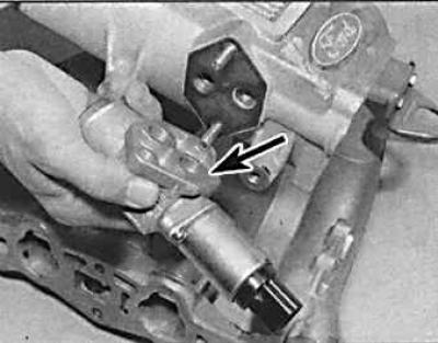 2. Снять разъем (указан стрелкой) с клапана управления, отогнув удерживающий зажим.