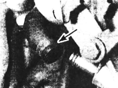 Рис. 13.2. Отсоедините масляный возвратный шланг (указан стрелкой) от корпуса масляного насоса.