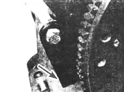 Figure 16.3. Homemade tool (indicated by the arrow) can be used to prevent the flywheel from…